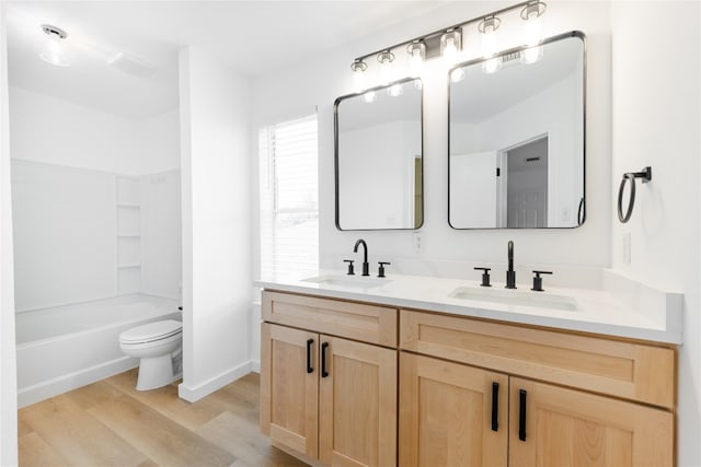 full bathroom with vanity, hardwood / wood-style flooring, toilet, and shower / bath combination