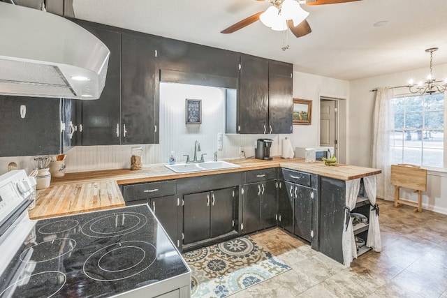 kitchen with sink, ceiling fan with notable chandelier, range, decorative light fixtures, and ventilation hood