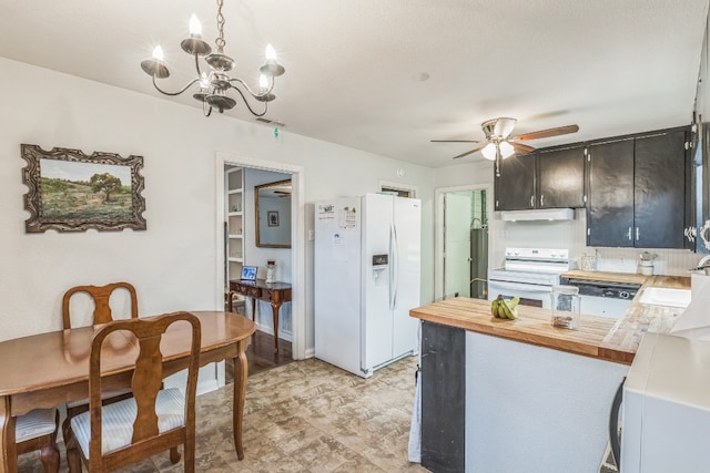 kitchen featuring white appliances, sink, ceiling fan with notable chandelier, wood counters, and kitchen peninsula