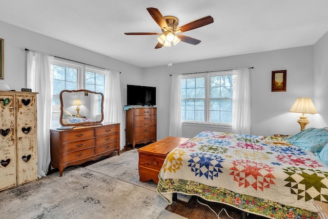 bedroom featuring multiple windows and ceiling fan