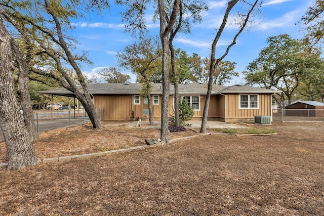 single story home with central AC unit and a carport