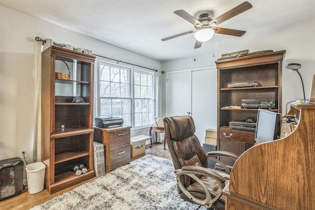 office area with light hardwood / wood-style floors and ceiling fan