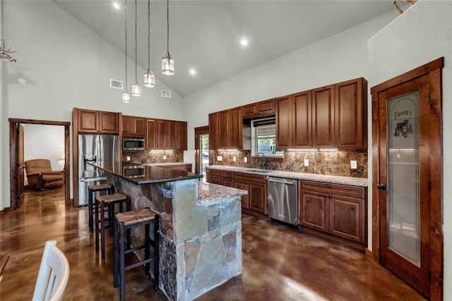 kitchen featuring light stone counters, appliances with stainless steel finishes, high vaulted ceiling, a center island, and sink