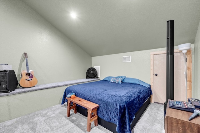 bedroom featuring light carpet, a textured ceiling, and lofted ceiling