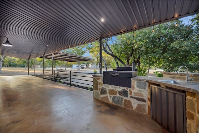 view of patio / terrace with an outdoor kitchen and sink