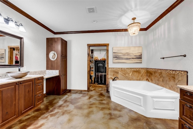 bathroom featuring vanity, a notable chandelier, ornamental molding, and a tub to relax in