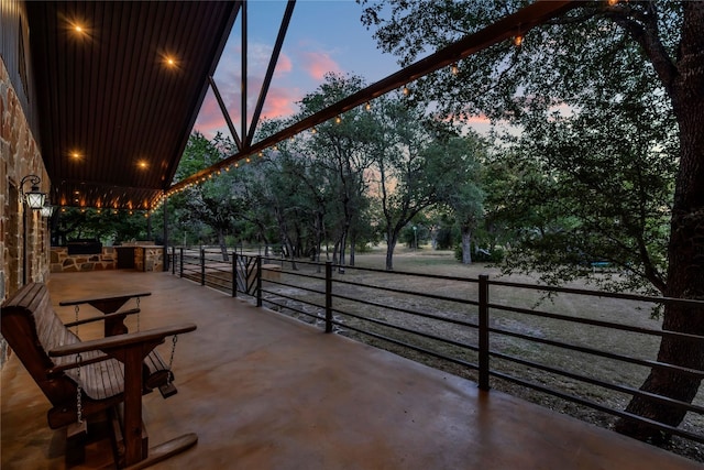 view of patio terrace at dusk