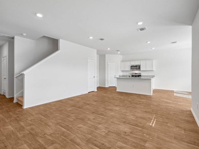 unfurnished living room featuring light hardwood / wood-style floors