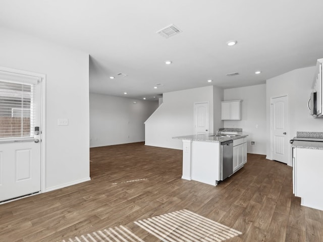 kitchen featuring white cabinets, sink, an island with sink, appliances with stainless steel finishes, and dark hardwood / wood-style flooring