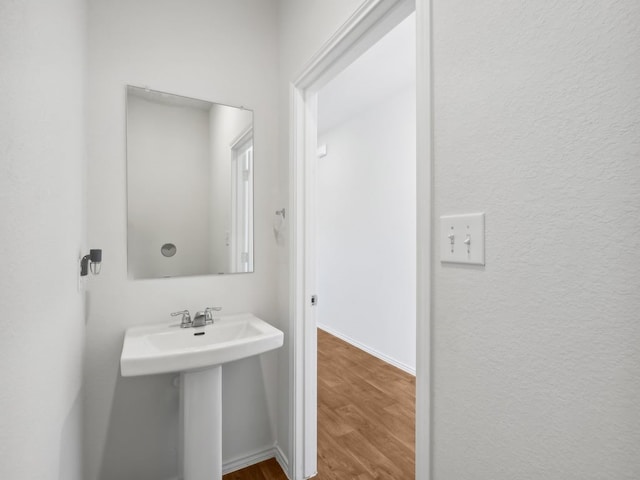 bathroom with hardwood / wood-style floors and sink