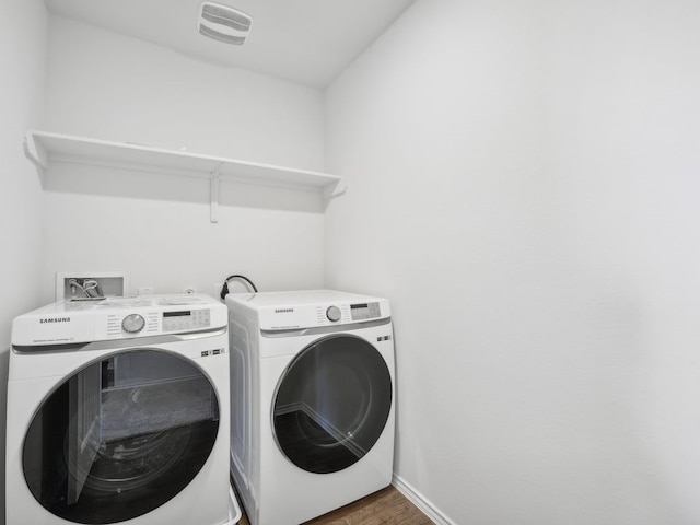 washroom featuring separate washer and dryer and dark wood-type flooring