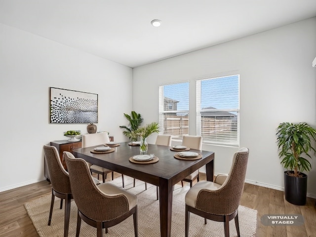 dining area with hardwood / wood-style flooring