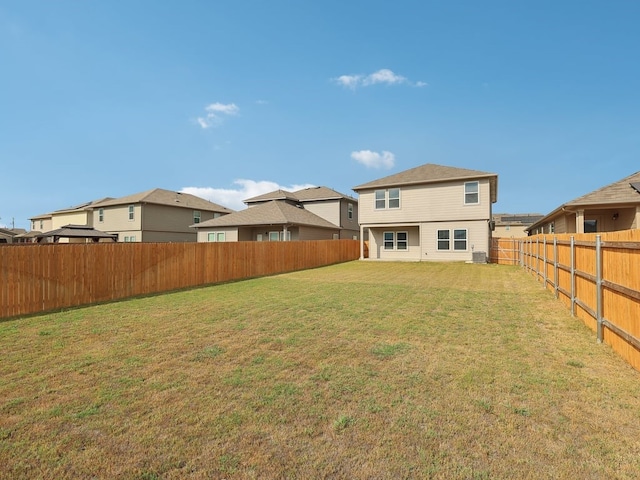 back of house with a yard and central AC unit