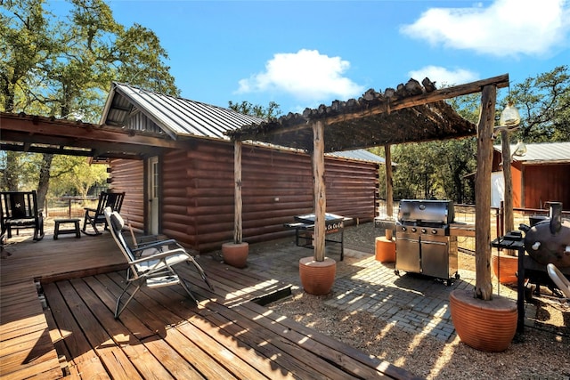 wooden terrace with a grill