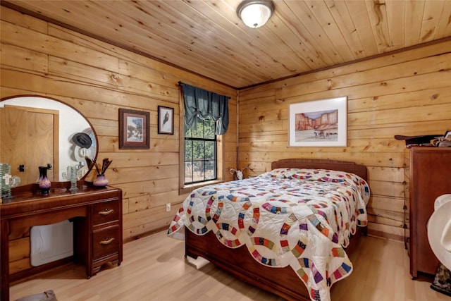 bedroom with light hardwood / wood-style floors, wood walls, and wood ceiling