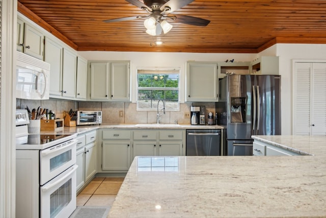 kitchen featuring wooden ceiling, sink, light tile patterned floors, appliances with stainless steel finishes, and tasteful backsplash