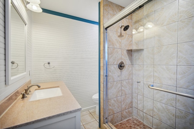 bathroom with vanity, toilet, tile patterned flooring, and an enclosed shower