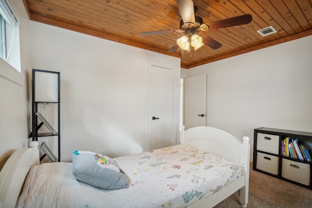 bedroom featuring ornamental molding, carpet, ceiling fan, and wooden ceiling