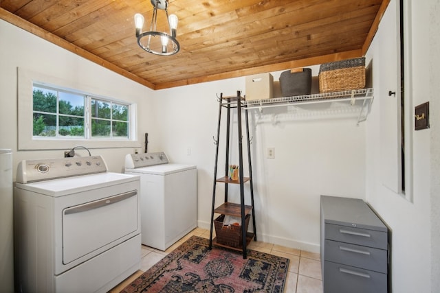 clothes washing area featuring a chandelier, wooden ceiling, washing machine and dryer, and light tile patterned floors