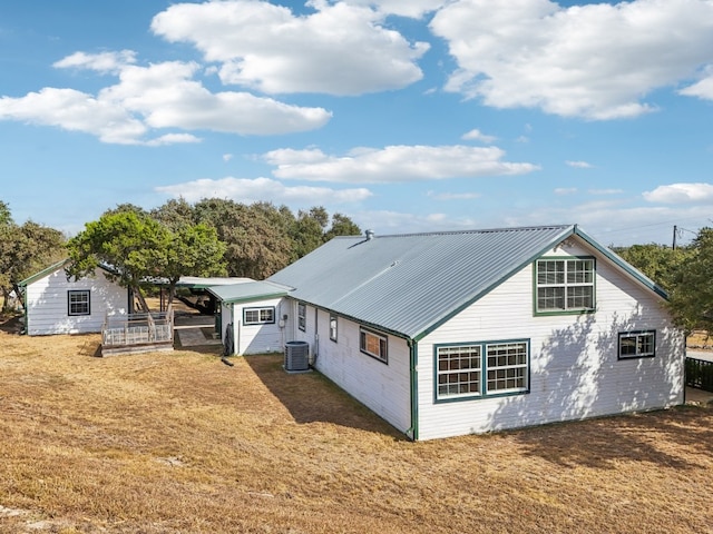 back of house with a yard and central AC unit