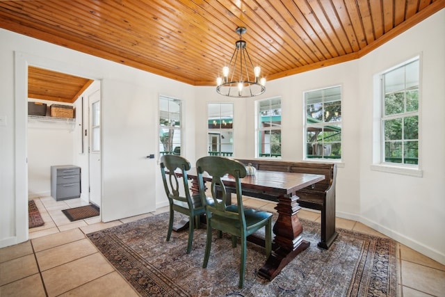 tiled dining area featuring crown molding, an inviting chandelier, and wooden ceiling