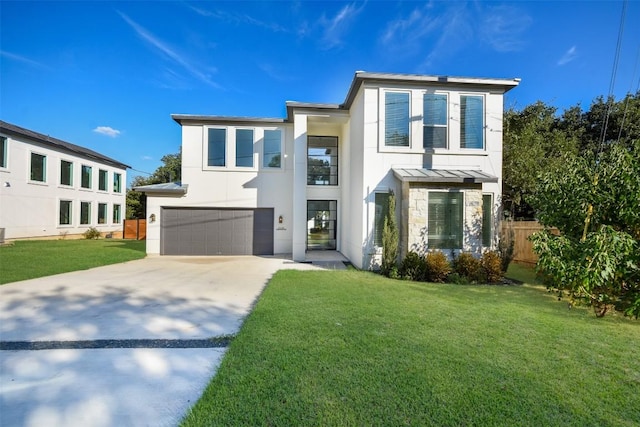 contemporary home with a front lawn and a garage