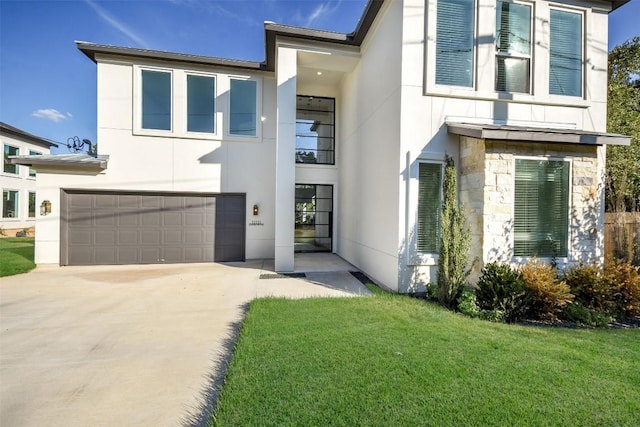 view of front of home with a front lawn and a garage