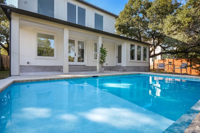 view of swimming pool with french doors