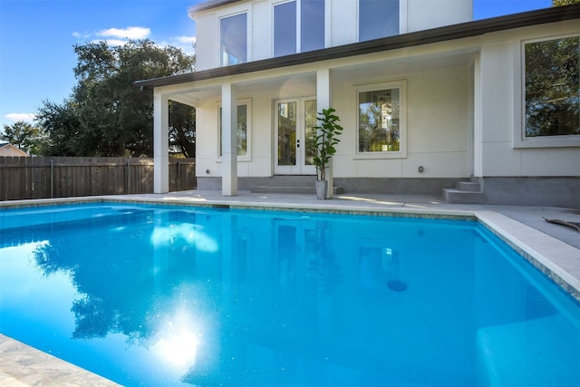 view of swimming pool with french doors