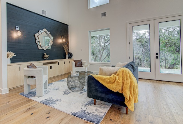 living room with french doors and light hardwood / wood-style floors