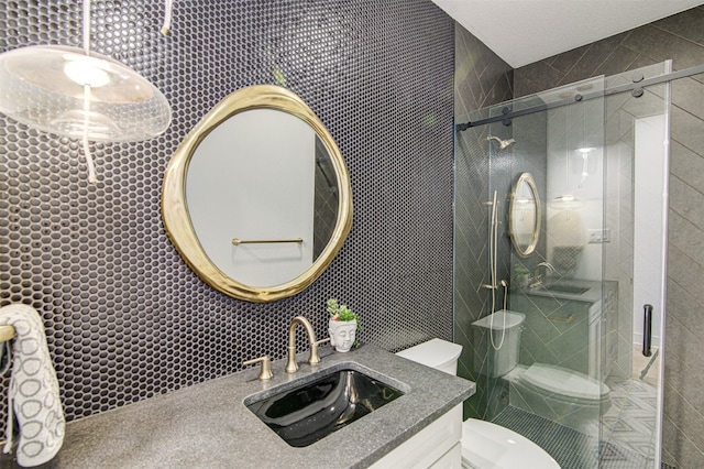 bathroom featuring vanity, toilet, and a shower with shower door