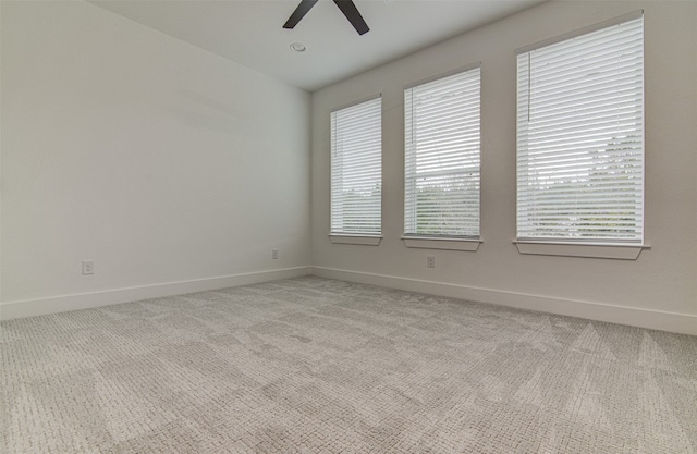 carpeted spare room with ceiling fan