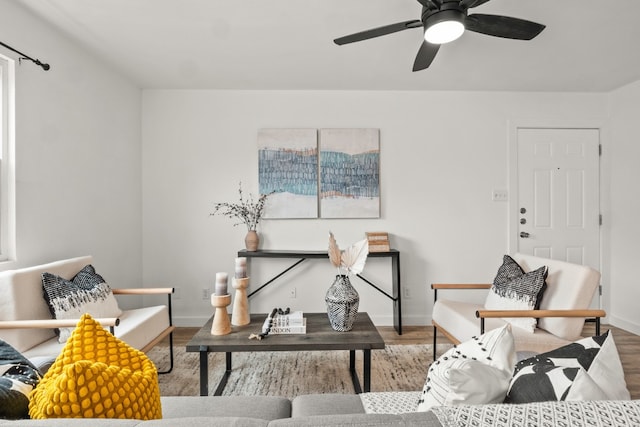 living room featuring hardwood / wood-style floors and ceiling fan