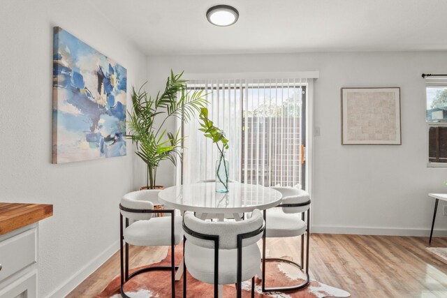 dining area with light hardwood / wood-style floors