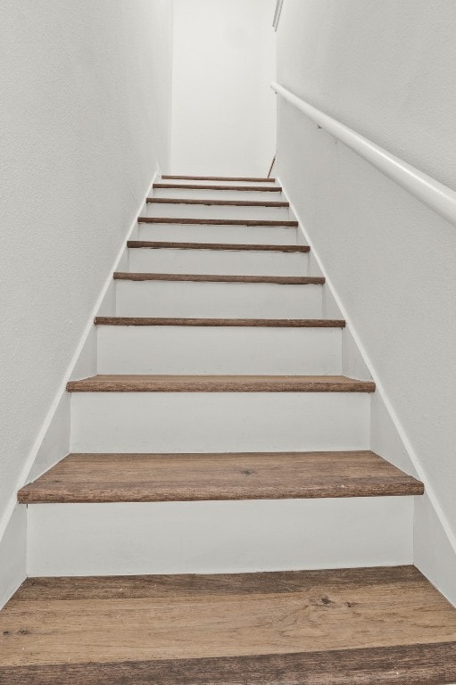 stairway with hardwood / wood-style floors