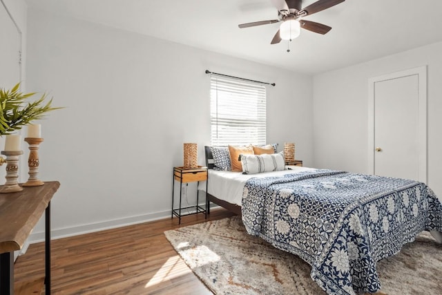 5616 Emerald Forest Dr Unit 101, Austin, TX 78745 - bedroom featuring wood finished floors, baseboards, and a ceiling fan