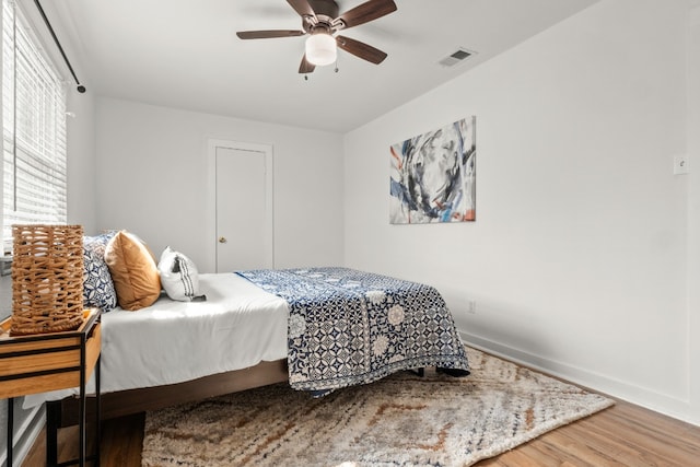 bedroom featuring hardwood / wood-style floors and ceiling fan