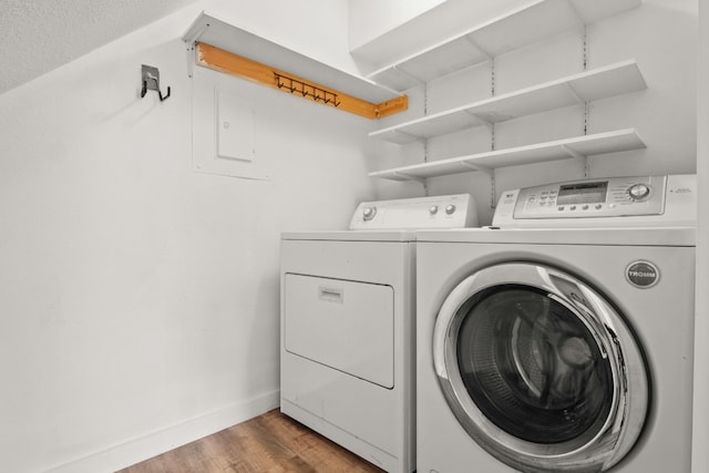 clothes washing area featuring hardwood / wood-style flooring and independent washer and dryer