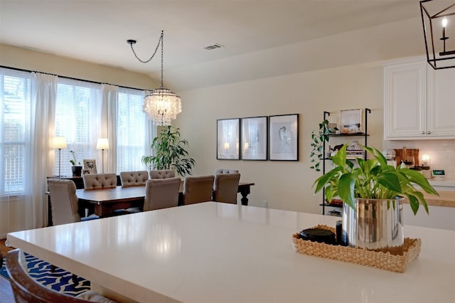 dining area featuring a notable chandelier