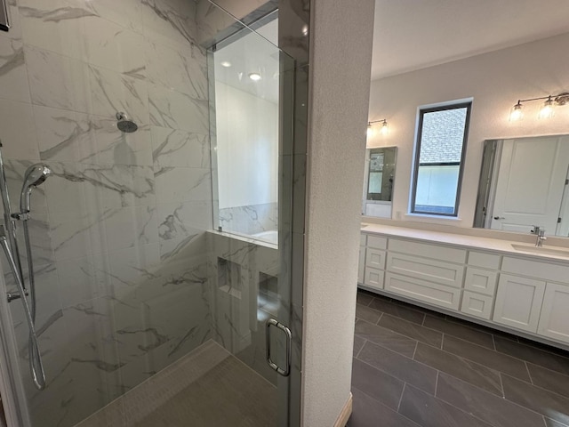 bathroom with vanity and a shower with shower door