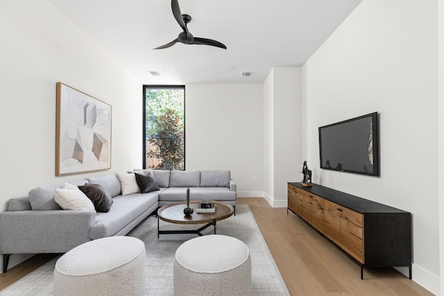 living room with expansive windows and light wood-type flooring