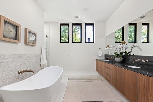 bathroom featuring plus walk in shower and vanity