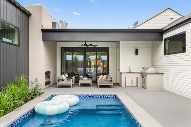 view of pool with an outdoor living space, a patio, area for grilling, and ceiling fan