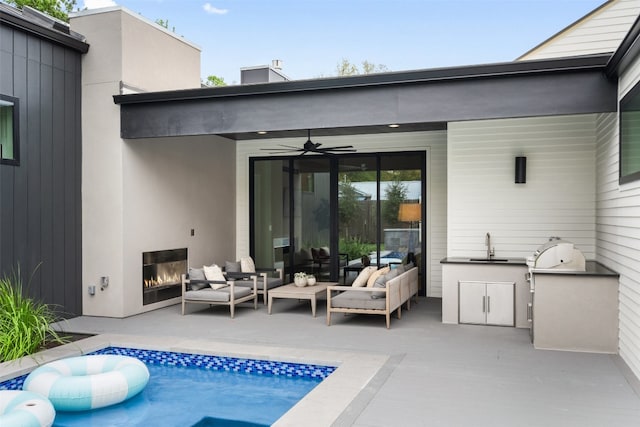 rear view of house featuring outdoor lounge area, ceiling fan, and a patio