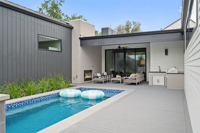 exterior space with outdoor lounge area, ceiling fan, and a patio area