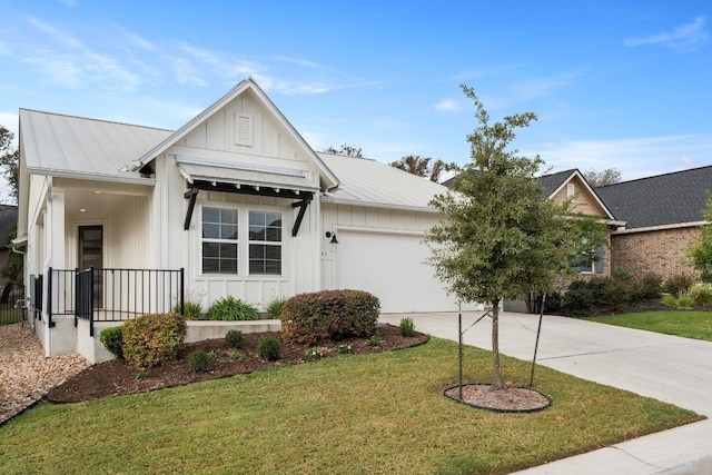 view of front of house with a garage and a front lawn