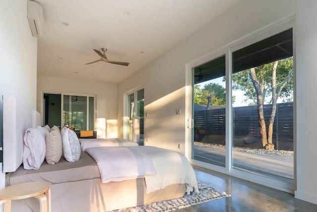 bedroom with a wall unit AC, access to exterior, and concrete floors