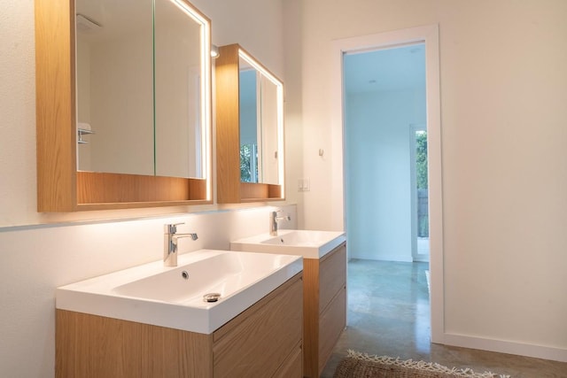 bathroom with vanity and concrete floors