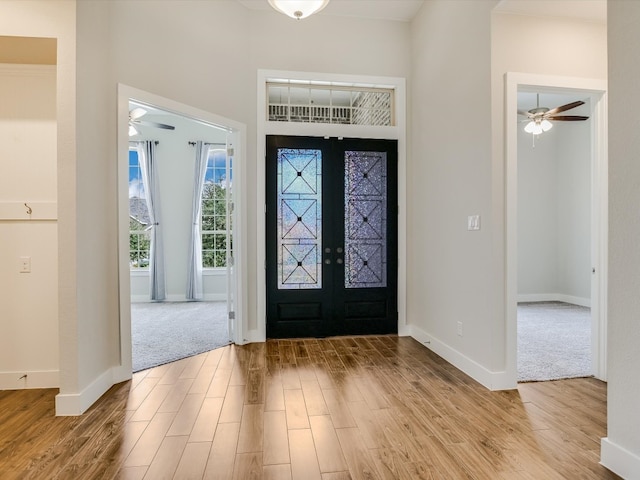 entryway featuring french doors, light hardwood / wood-style floors, and ceiling fan