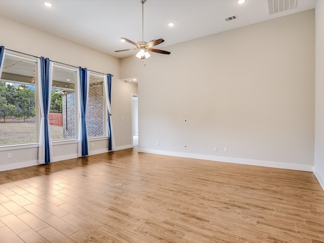 empty room with light hardwood / wood-style floors and ceiling fan